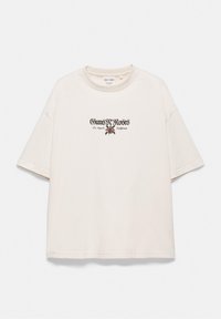 T-shirt blanc à manches courtes avec le texte Guns N' Roses, un graphisme de rose et "Los Angeles California" imprimé au centre à l'avant.