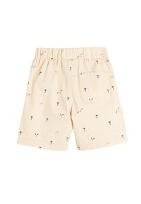 Helle beigen Shorts mit einem elastischen Bund, die mit einem Muster von Möwen und Palmen versehen sind, und einer einzelnen Gesäßtasche.