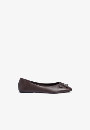 Brown leather ballet flat with a rounded toe, featuring a bow accent and a smooth texture. Flat sole for easy wear.