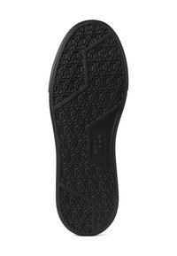 Suola di scarpa nera in gomma testurizzata per una migliore aderenza, caratterizzata da un motivo esagonale e da un bordo del tallone liscio e arrotondato. Progettata per resistenza e trazione.