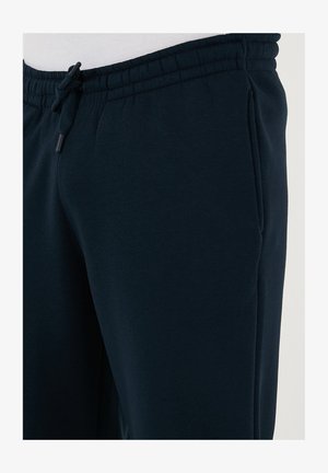 Navy blå sweatpants lavet af blødt stof, med en elastisk talje med snørre og sidelommer.