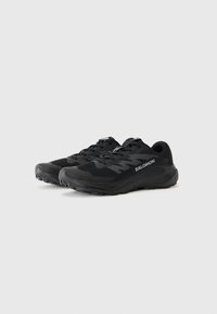 Black running shoes with a mesh upper, textured design, and rubber outsole. Features laces and a prominent logo on the side.