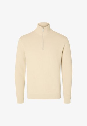 Beige, ribbet striktrøje med høj krave og lynlås halvlængde. Har lange ærmer og en tætsiddende kant.