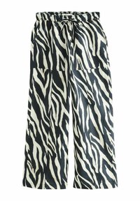 Wijd-uitlopende broeken in zwart-wit zebra print, met een elastische tailleband met een trekkoord en twee zijzakken. Soepele textuur.