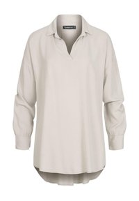 Blusa lunga beige chiaro a maniche lunghe con scollo a V, vestibilità ampia e orlo leggermente curvo. Realizzata in tessuto morbido e texture con maniche a sbuffo.