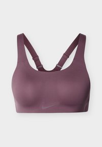 Αθλητικό σουτιέν Nike σε βαθύ βιολετί χρώμα· λεία ύφανση, φαρδιές τιράντες και σχέδιο racerback. Διαθέτει διακριτικό λογότυπο στο μπροστινό μέρος.