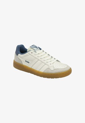 White sneaker with gum sole, perforated toe, blue suede accents, and three white stripes. Features lace-up design and logo on tongue.