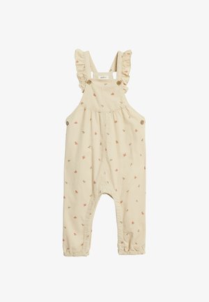 Beiget puuvillaiset haalarit röyhelöillä koristelluilla olkahihnoilla, pienillä kukkakuoseilla, puisilla nappeilla ja nilkoissa joustinneuloksilla.