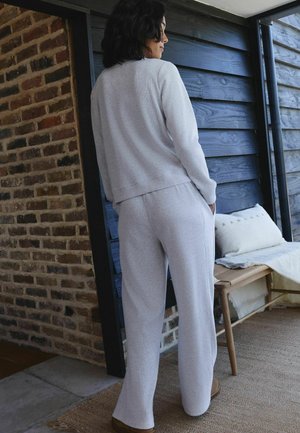 Ljusgrå sweatshirt och matchande byxor i mjukt tyg, med avslappnad passform och minimalistisk design, med ribbad textur.