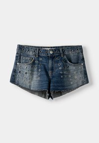 Denim shorts in dark blue with a frayed hem, featuring metal grommets arranged vertically across the front, five-pocket design, and a button closure.