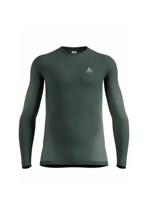 Dark green long-sleeve athletic shirt with gradient dotted pattern on sleeves and sides, featuring a small logo on the left chest.