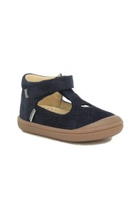 Chaussure pour enfant en suede bleu marine avec des accents brillants, côtés ouverts et une sangle Velcro. Semelle en caoutchouc avec une texture antidérapante pour une meilleure stabilité.