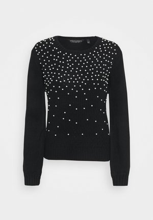 Zwarte gebreide trui met lange mouwen en een ronde hals, versierd met verspreide kleine witte parels op de borst en schouders.