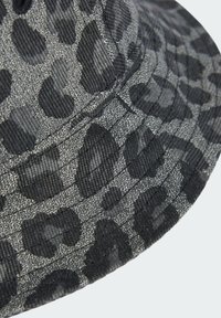 Black and gray bucket hat featuring a leopard print pattern, made of textured fabric with stitched accents and a round, downward-sloping brim.