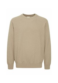 Beige knitted sweater with a crew neck, long sleeves, and ribbed cuffs. The texture appears soft and slightly thick. No visible patterns or accents.