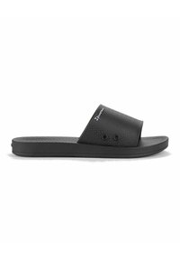 Sandalias de slide negras con un upper texturizado y dos agujeros decorativos; diseñadas con una suela plana y una silueta simple. Logo de la marca visible.