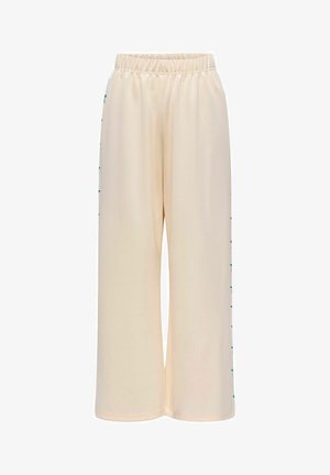 Beežid laiad püksid elastse vöökohtaga, millel on sirged rohelised dekoratiivsed aktsendid külgõmblustes, valmistatud siledast kangast.