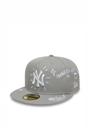 Gray New York Yankees baseball cap with white embroidered logos and doodles, including sparkles and text, shown at a three-quarter angle.