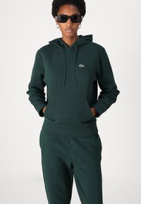 Lacoste Tepláky - sinople