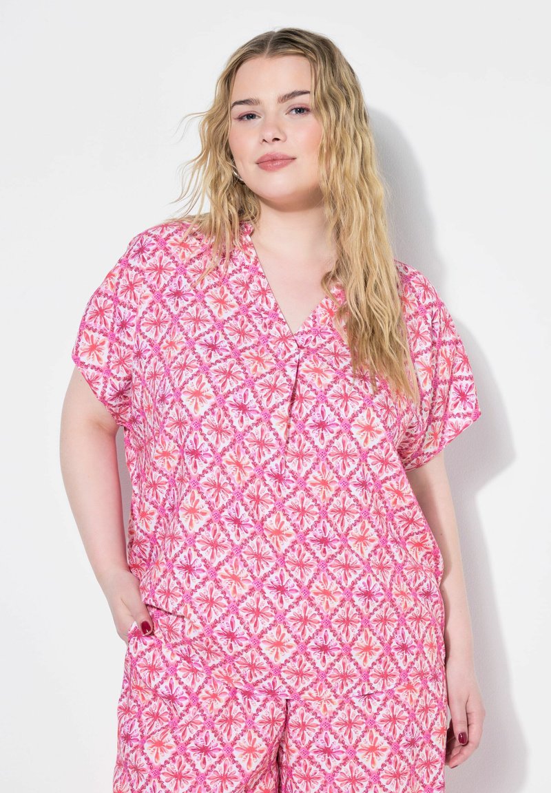 Top con motivo floreale rosa, con scollatura a V e maniche corte, caratterizzato da una vestibilità ampia e una texture delicata. Adatto per l'abbigliamento casual.