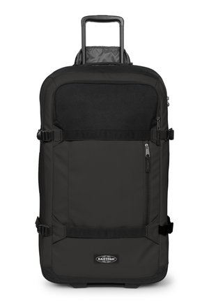 Maleta blanda rectangular negra con asa extensible, correas de compresión laterales, cremallera en el bolsillo delantero y logo de Eastpak en el frente.