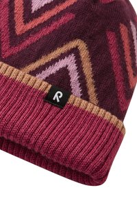 Knitted beanie in burgundy with geometric patterns in shades of pink and gold. Features a ribbed cuff and a small black label with "R."