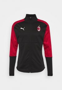 Black athletic jacket with red patterned sleeves, zip closure, and high collar. Features a white logo on the chest and a star above it.