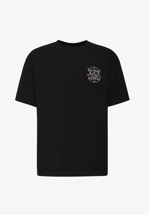 Camiseta de algodón negra con mangas cortas, corte holgado y un detalle de texto bordado en blanco en el pecho que dice "NO SOY DE PARÍS, MADAME."