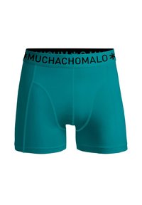 Turquoise boxer shorts featuring a black elastic waistband with "MUCHACHOMALO" logo, made from a smooth, stretchy fabric for comfort.