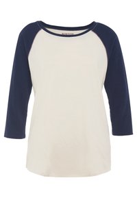 Krämfärgad och marinblå raglanärmad skjorta med rundad halsringning och ärmar av medellängd. Mjuk bomullsmaterial med kontrasterande färgdetaljer och sömmar.