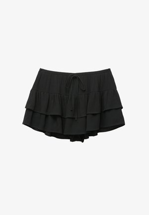 Black ruffled swim shorts with a drawstring waist. Features three tiered layers, made of lightweight fabric. Soft texture with a relaxed fit.