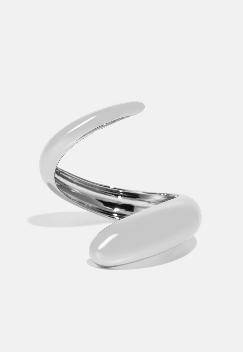 Sleek metallic bracelet with a twisted design, featuring smooth, shiny surfaces in silver and a rounded end cap. Lightweight and flexible.