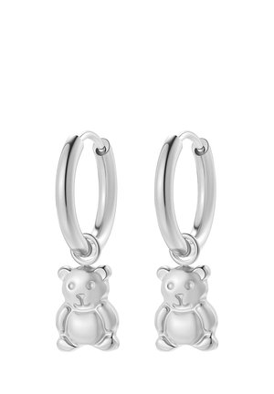 Pendientes de aro de plata, cada uno con un pequeño colgante de osito de peluche, acabado liso y brillante, exhibidos sobre un fondo blanco.