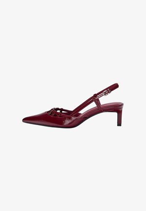Burgundy patent leather slingback shoe with pointed toe, mid-height heel, and buckle strap on white background.