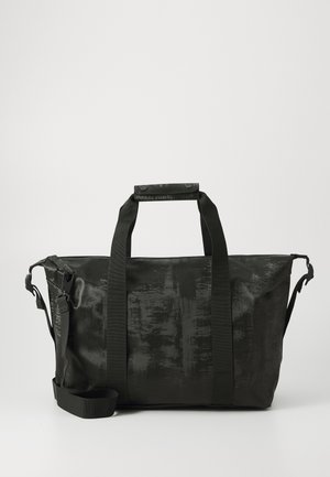 Black duffel bag with a textured surface, dual handles, adjustable shoulder strap, and a zip closure. Material is sturdy and water-resistant.