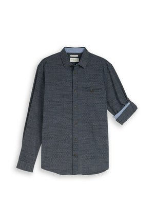 Donkergrijs overhemd met lange mouwen, knopen, subtiel patroon, één borstzak en één opgerolde mouw die een lichtblauwe binnenvoering toont.