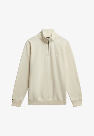 Cremfarbener Pullover mit hohem Kragen, halber Reißverschluss auf der Vorderseite, weicher Textur und gerippten Bündchen und Saum. Kleines Logo auf der Brust.