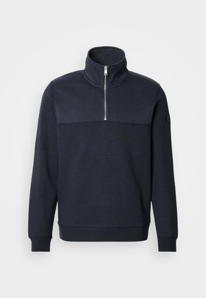 Marineblaue Sweatshirt mit hohem Kragen und einem Viertelreißverschluss auf der Vorderseite, mit einem farbigen Blockdesign, gerippten Bündchen und einer glatten Textur.