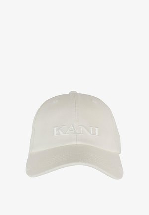 Fehér pamut baseballsapka ívelt ernyővel, az elején hímzett "KANI" felirattal. A koronáján szellőzőlyukakkal rendelkezik.