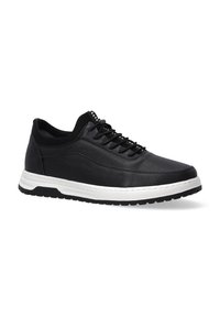Black athletic shoe featuring a textured leather upper, lace-up design, and a white midsole contrasting with a black rubber outsole.