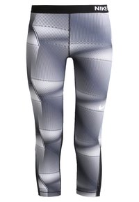 Legginsy sportowe Nike z czarnym pasem w talii i białym geometrycznym wzorem w odcieniach szarości, z logo Nike na prawej nodze.