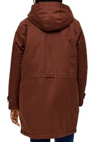 Hnedá kapucňová parka s obtiahnutým pásom, bočnými vreckami a zapínaním na cvoky, vyrobená z hladkej, vodoodolnej tkaniny.