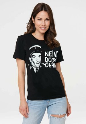 Black cotton t-shirt featuring a graphic of a shocked figure in a cap, with white text reading "NEIN! DOCH! OHHH!" across the front.
