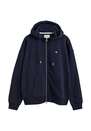 Navy zip-up hoodie made of cotton blend, featuring a front pocket, drawstring hood, and embroidered logo on the chest. Soft texture.