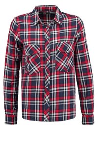 Chemise à carreaux rouge, marine et blanche à manches longues, boutonnée avec deux poches poitrine devant et un col classique.