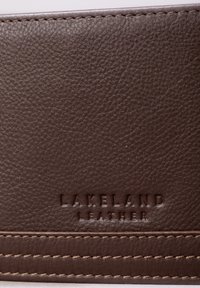 Brown leather wallet with textured surface, featuring embossed "Lakeland Leather" logo and contrasting light stitching.