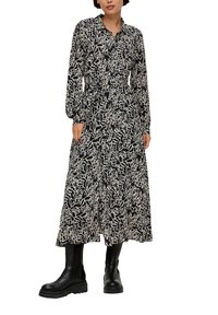 Maxikleid mit langen Ärmeln, schwarzes und beiges abstraktes Muster, strukturierter Kragen, elastischer Bund, kombiniert mit knielangen schwarzen Stiefeln.