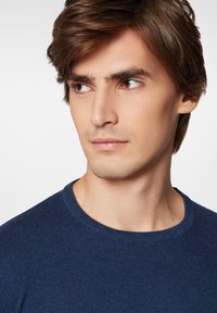 Granatowy sweter z dzianiny z okrągłym dekoltem i teksturowanym materiałem, cechujący się dopasowanym krojem oraz delikatnymi prążkowanymi akcentami przy szyi.