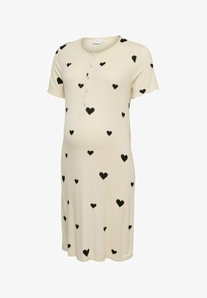 Kort crèmekleurig jurkje met zwarte hartjespatronen, korte mouwen, een ronde halslijn en een knoopsluiting aan de voorkant.