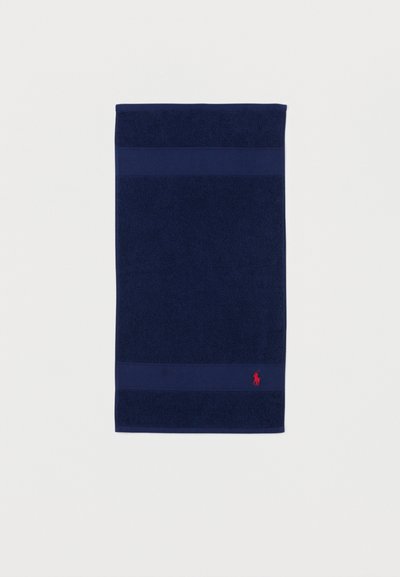 Navy blue rectangular bath towel with textured bands near edges and small red embroidered horse logo at bottom corner.